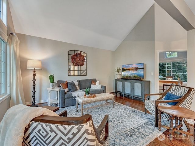 a living room with furniture a rug and a large window