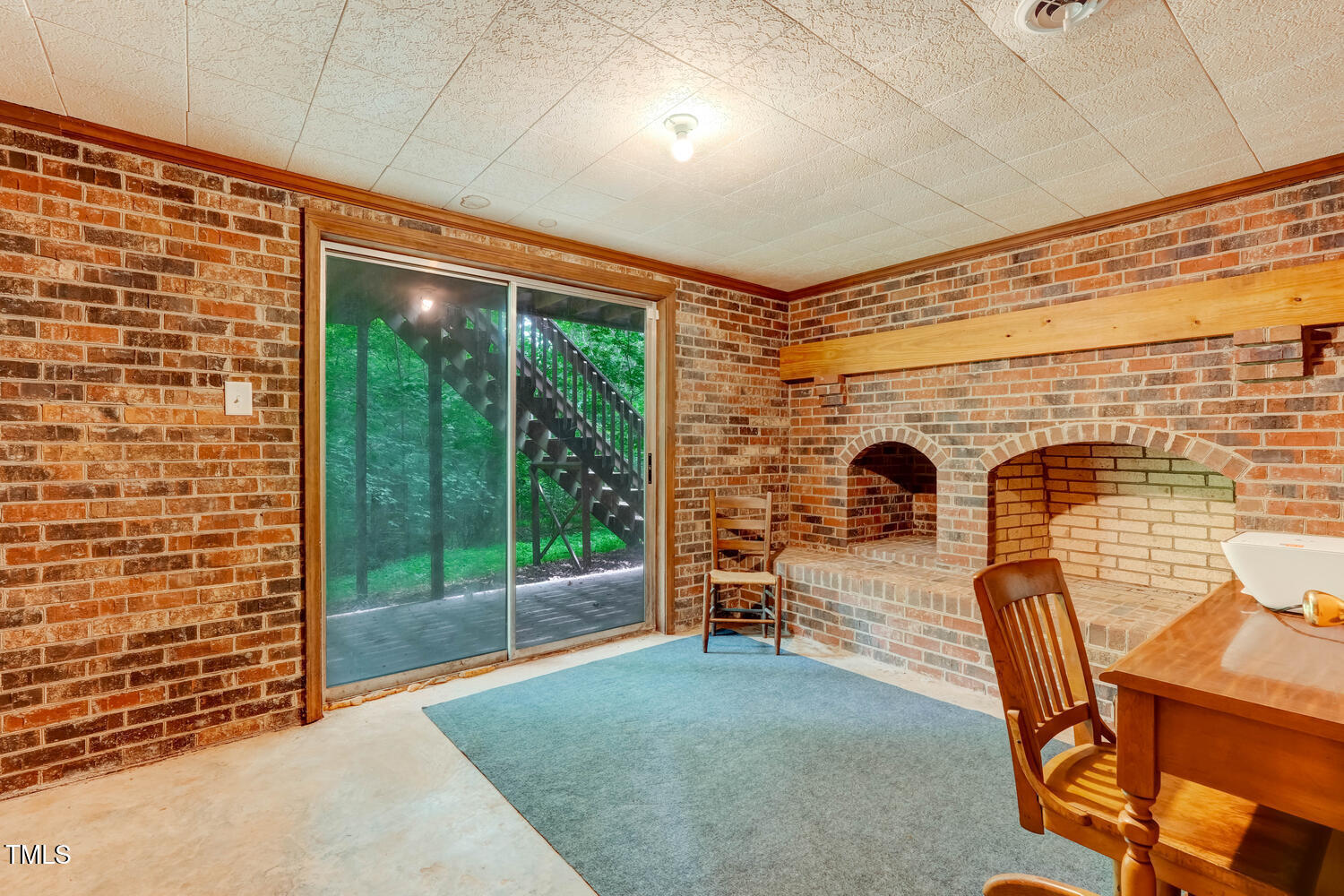 4272 Boyd Wright Road Burlington, NC 27215 - Photo 25 of 38 Another view of the basement room with sliding doors and full fireplace.