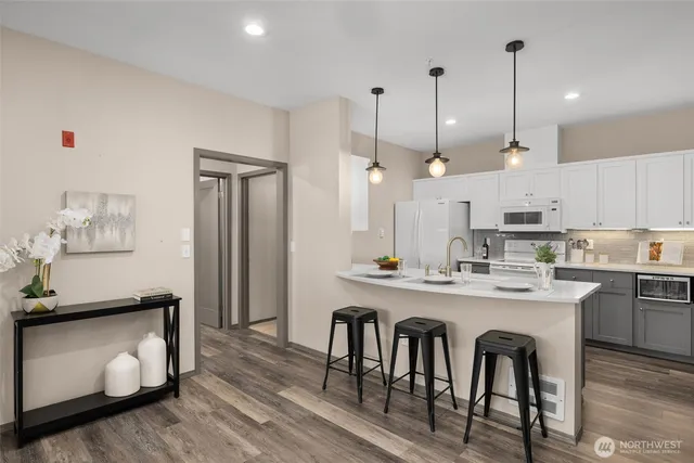 a kitchen with a sink a refrigerator and a stove top oven