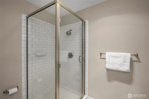 a bathroom with a shower and a glass door