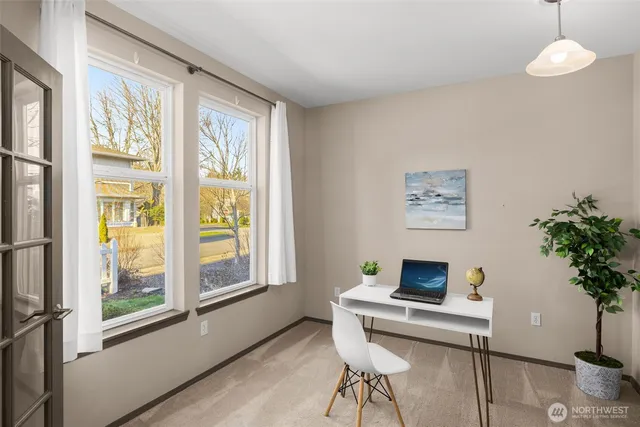 a kitchen with kitchen island stainless steel appliances a table chairs refrigerator and sink