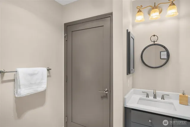 a kitchen with stainless steel appliances granite countertop a table chairs in it and wooden floors