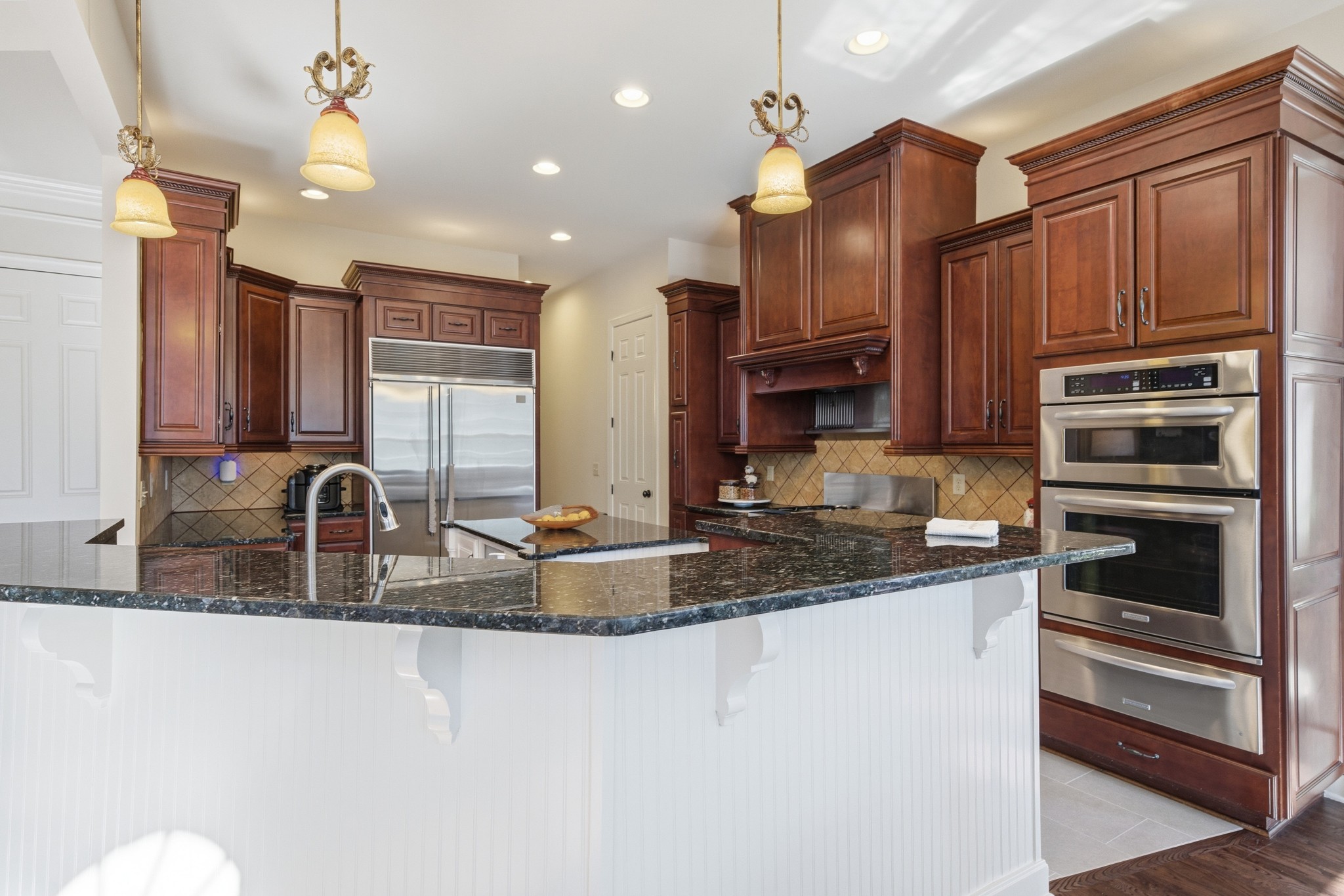 319 Hamlets End Way Franklin, TN 37067 - Photo 16 of 54 a kitchen with stainless steel appliances granite countertop a sink refrigerator and cabinets