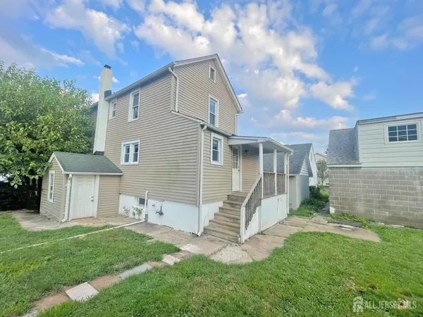 a view of a house with a yard and fence