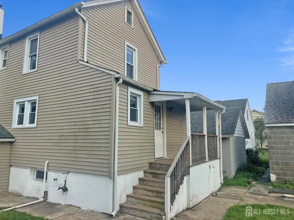 a front view of a house with wooden stairs