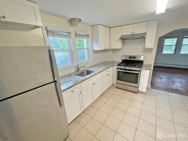 a kitchen with a stove a sink and a refrigerator