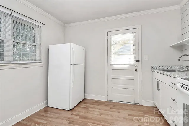 a kitchen with a refrigerator and a stove