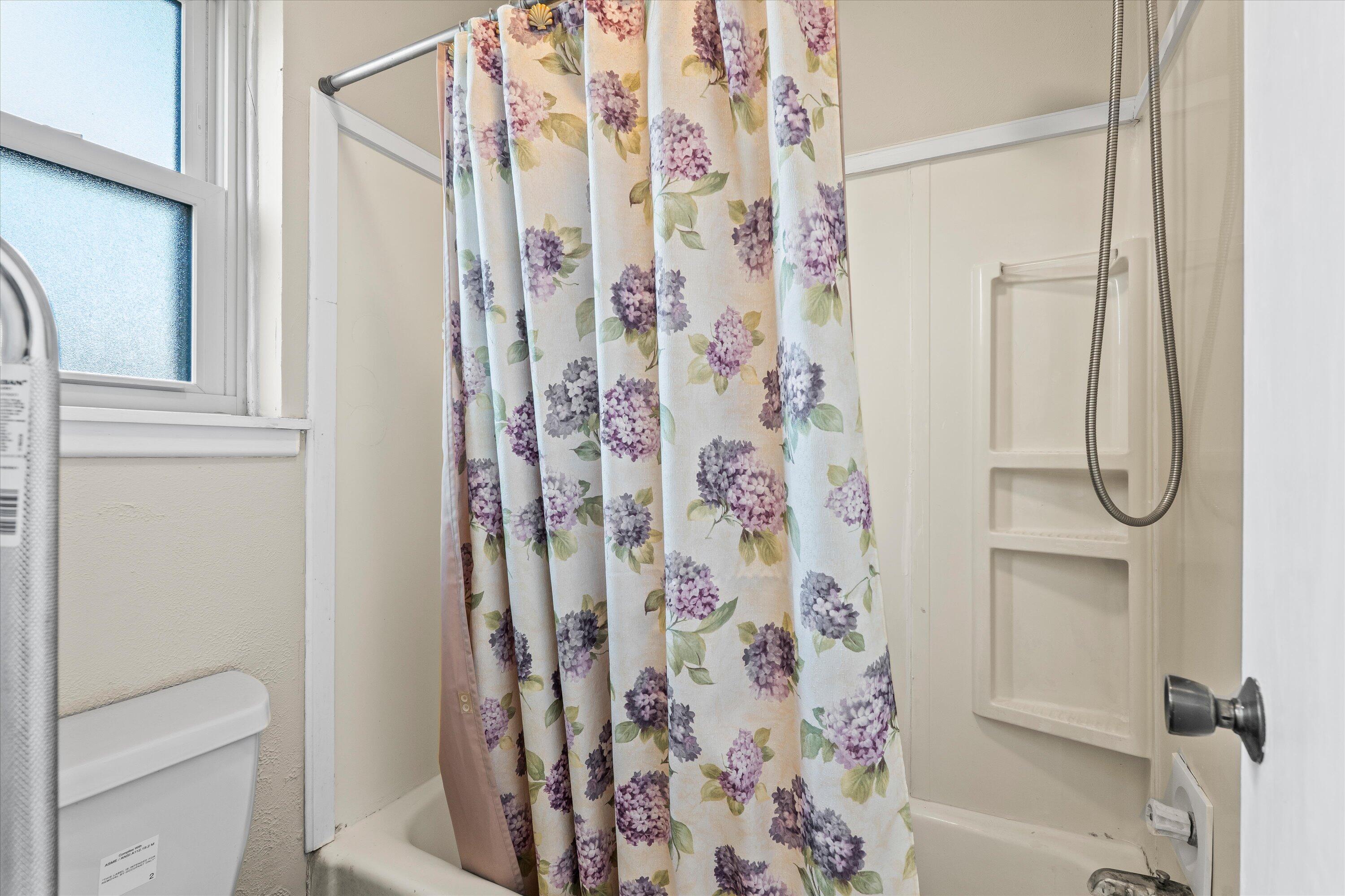 4520 54th Street Lubbock, TX 79414 - Photo 17 of 32 a bathroom with a shower curtain