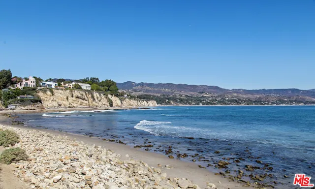 a view of an ocean beach and mountain