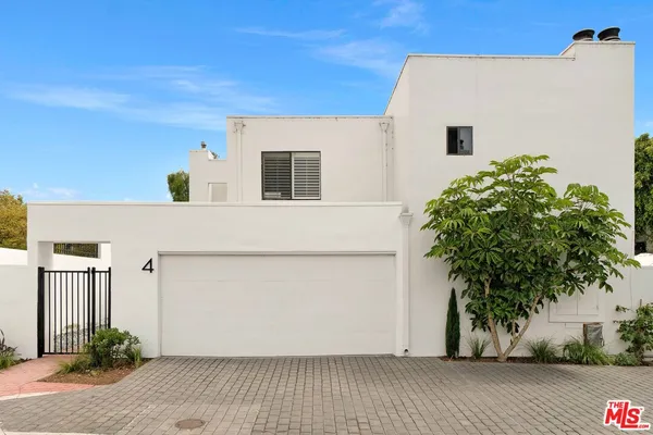 a view of a front of house with potted plants