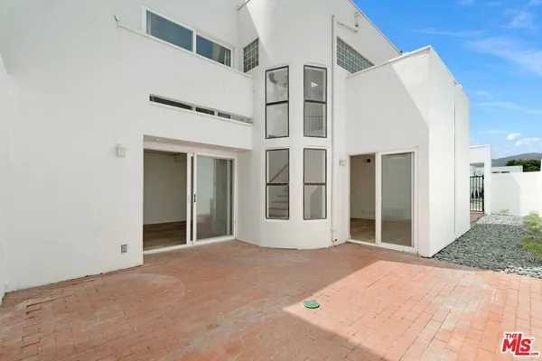 a view of backyard with large windows