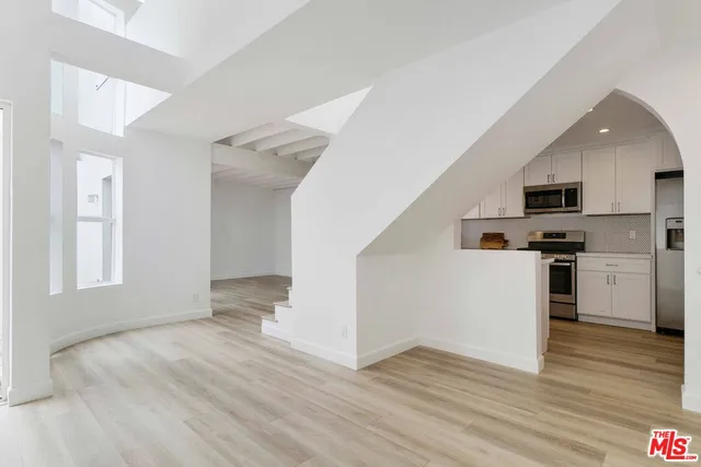 a view of kitchen with wooden floor and electronic appliances