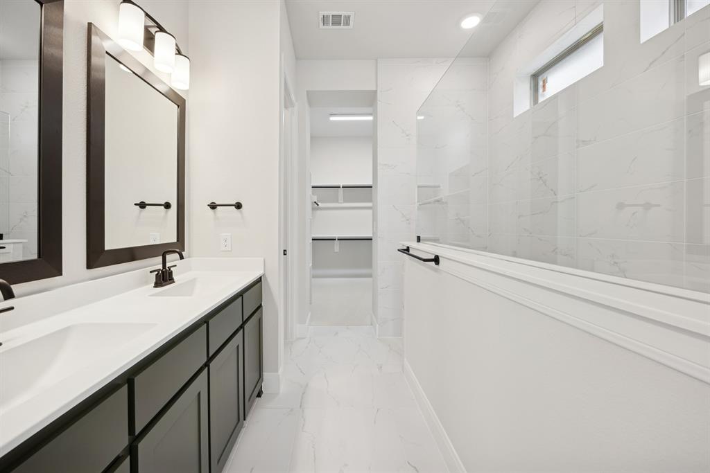 1837 Lightner Road Van Alstyne, TX 75495 - Photo 13 of 30 a bathroom with a double vanity sink a mirror and a shower
