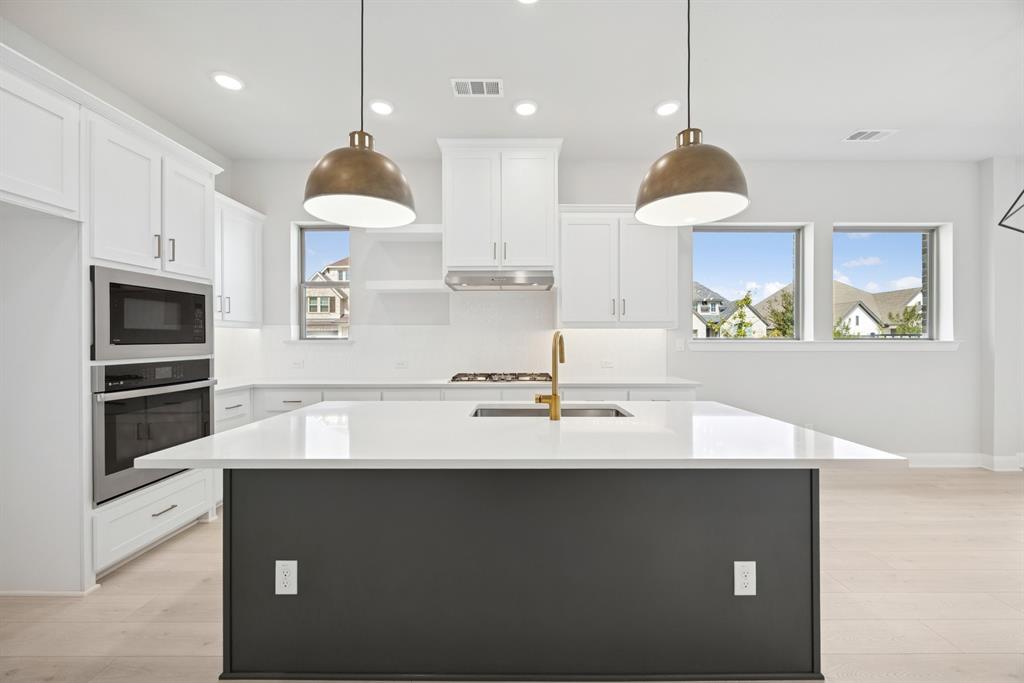 1837 Lightner Road Van Alstyne, TX 75495 - Photo 18 of 30 a kitchen with kitchen island granite countertop a sink a counter space appliances and cabinets