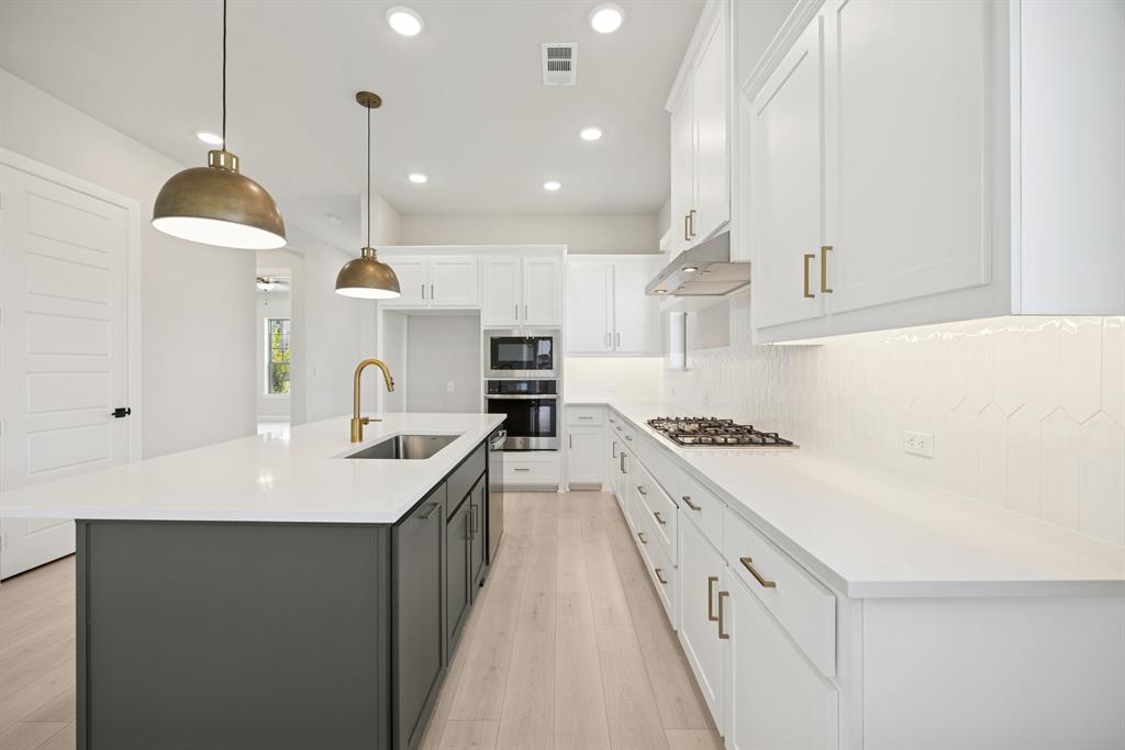 1837 Lightner Road Van Alstyne, TX 75495 - Photo 20 of 30 a large kitchen with kitchen island a sink a stove and a refrigerator