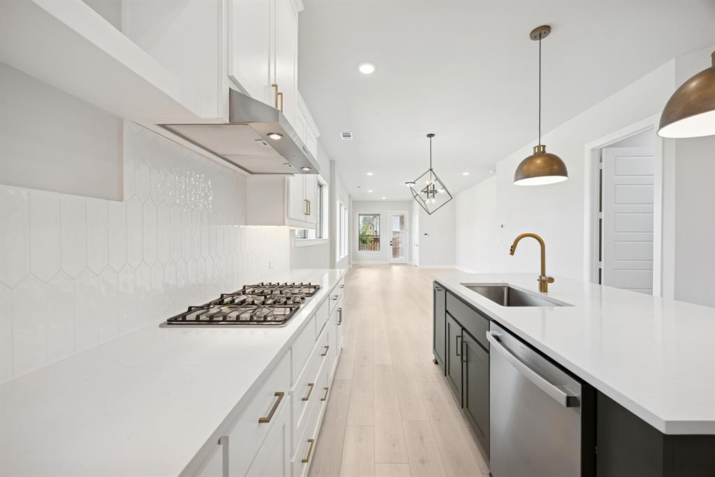 1837 Lightner Road Van Alstyne, TX 75495 - Photo 21 of 30 a kitchen with stainless steel appliances granite countertop a sink a stove a refrigerator and a wooden floor