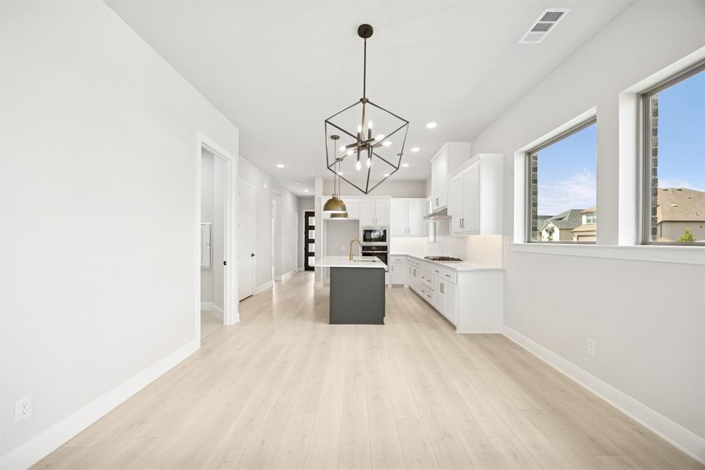 1837 Lightner Road Van Alstyne, TX 75495 - Photo 25 of 30 a view of a kitchen with a sink and dishwasher a refrigerator with wooden floor