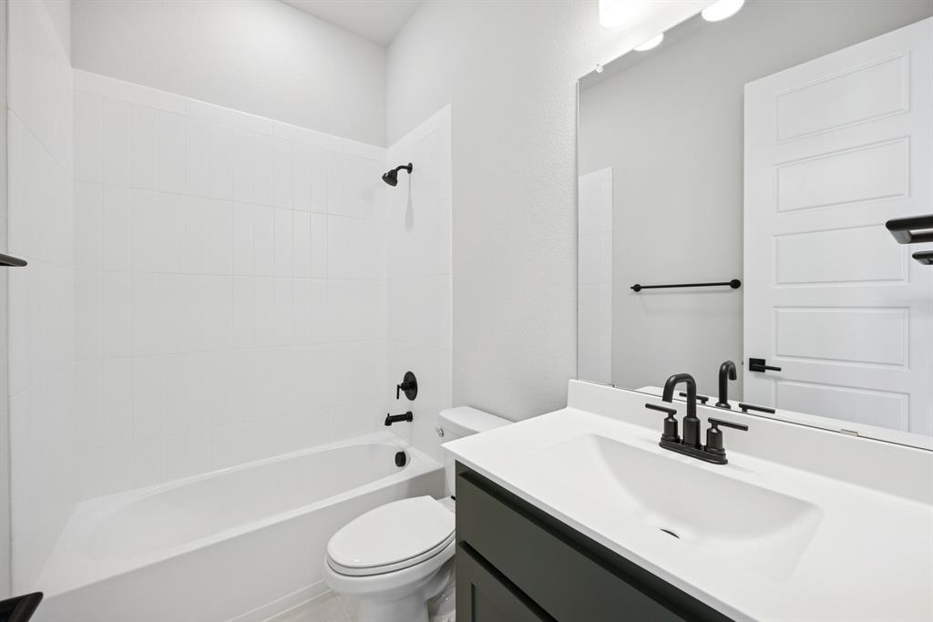 1837 Lightner Road Van Alstyne, TX 75495 - Photo 30 of 30 a bathroom with a sink a toilet and a bathtub