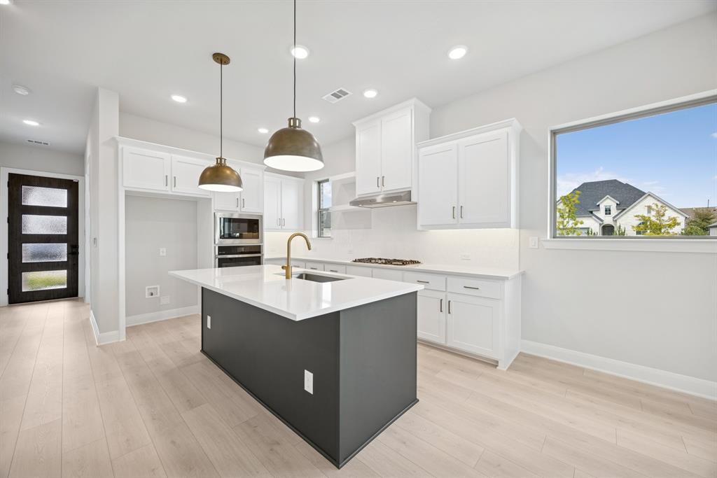 1837 Lightner Road Van Alstyne, TX 75495 - Photo 6 of 30 a kitchen with a sink window and cabinets