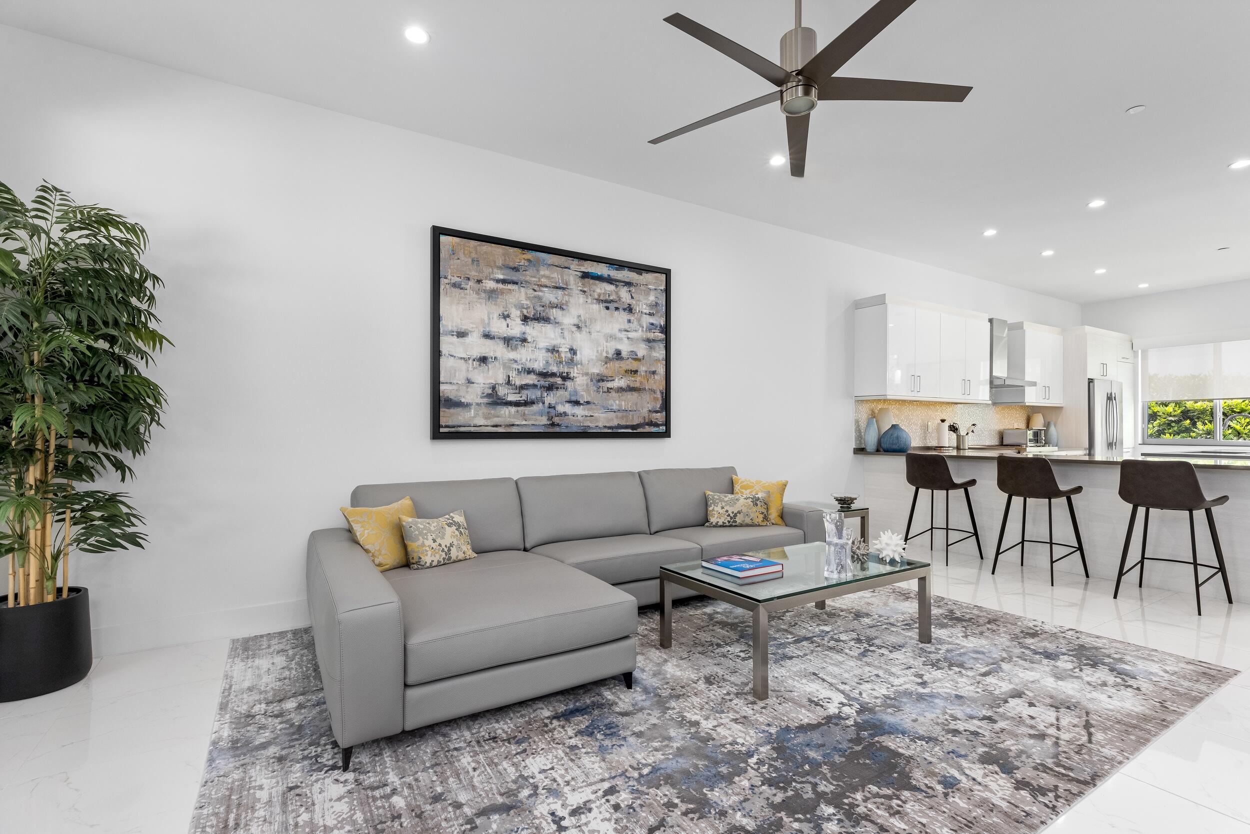 1851 Northwest 40th Drive Boca Raton, FL 33431 - Photo 12 of 42 a living room with furniture and a potted plant