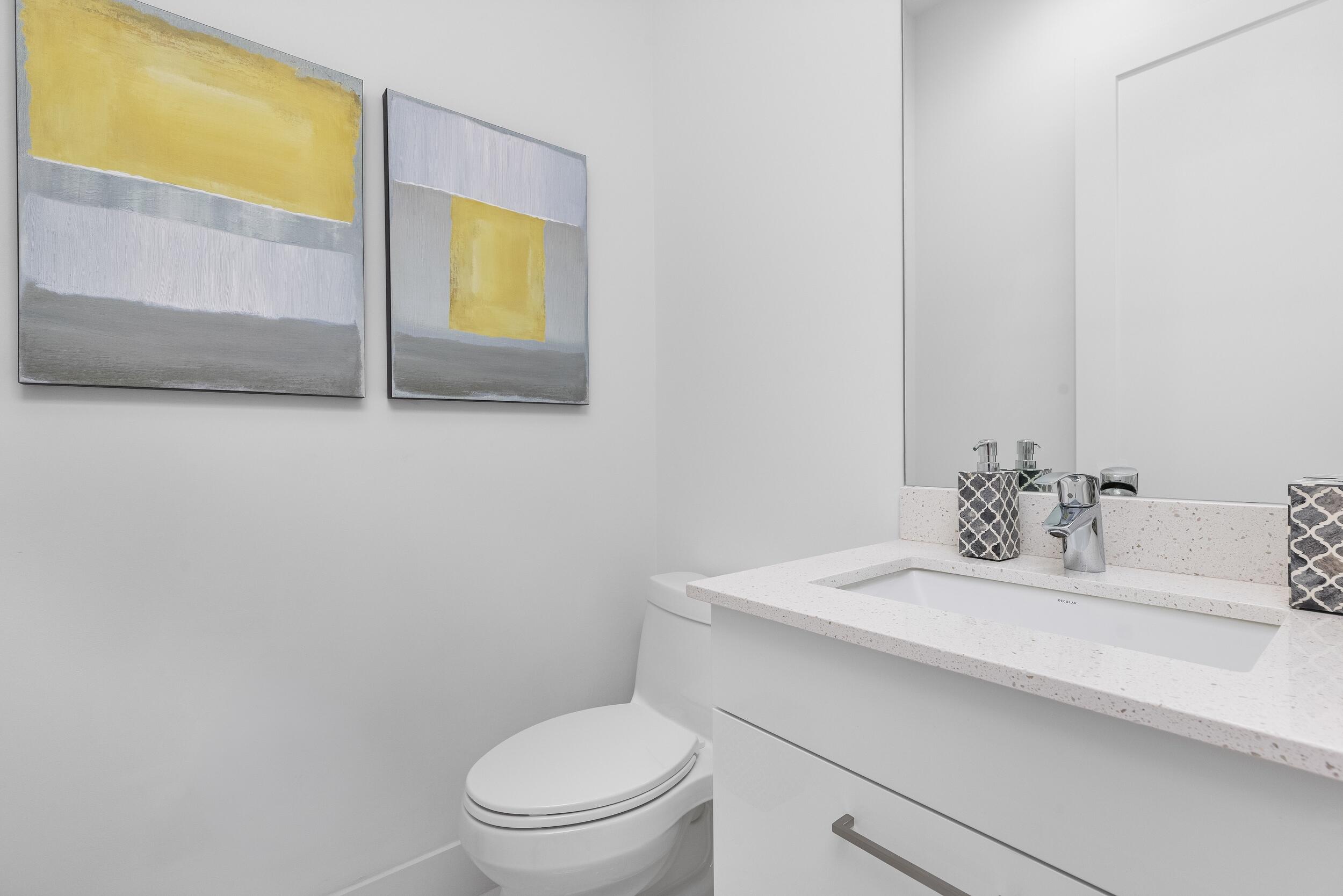 1851 Northwest 40th Drive Boca Raton, FL 33431 - Photo 24 of 42 a bathroom with a sink a toilet and mirror