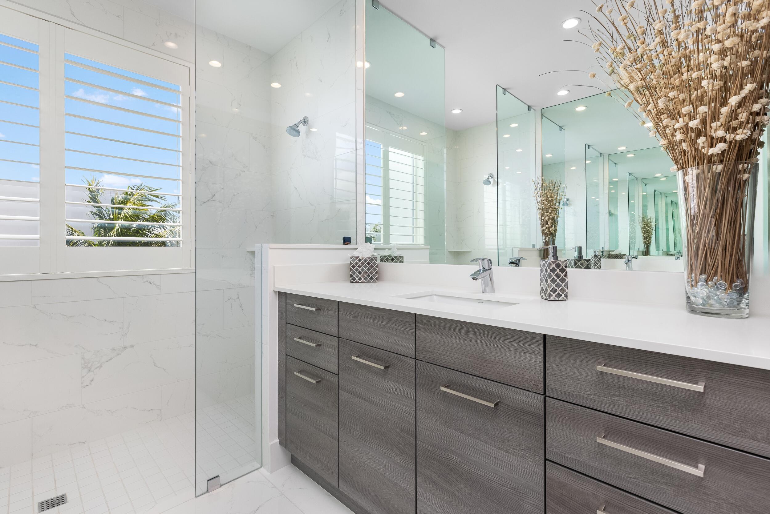 1851 Northwest 40th Drive Boca Raton, FL 33431 - Photo 28 of 42 a bathroom with a double vanity sink and a mirror