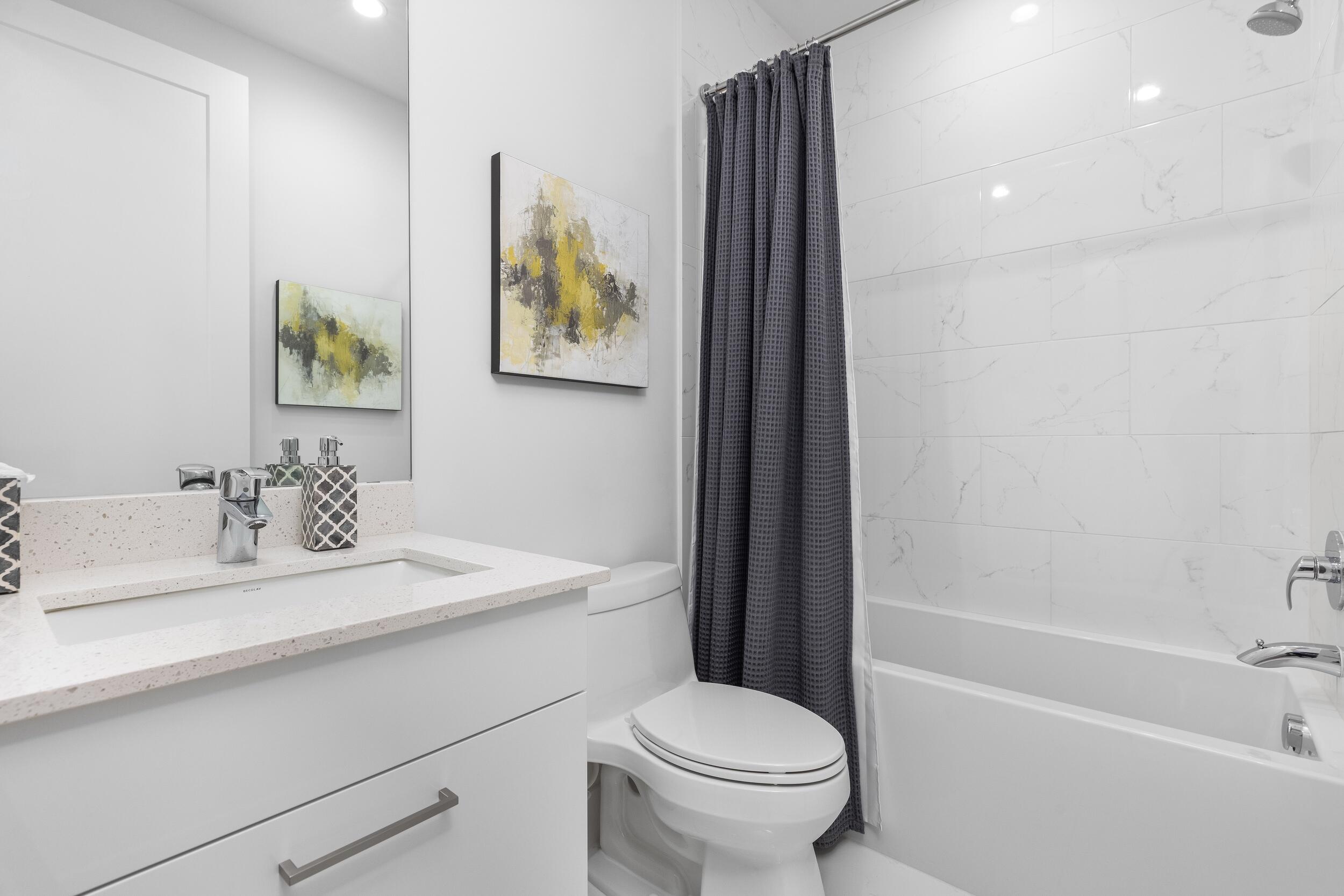 1851 Northwest 40th Drive Boca Raton, FL 33431 - Photo 33 of 42 a bathroom with a sink toilet and a bathtub