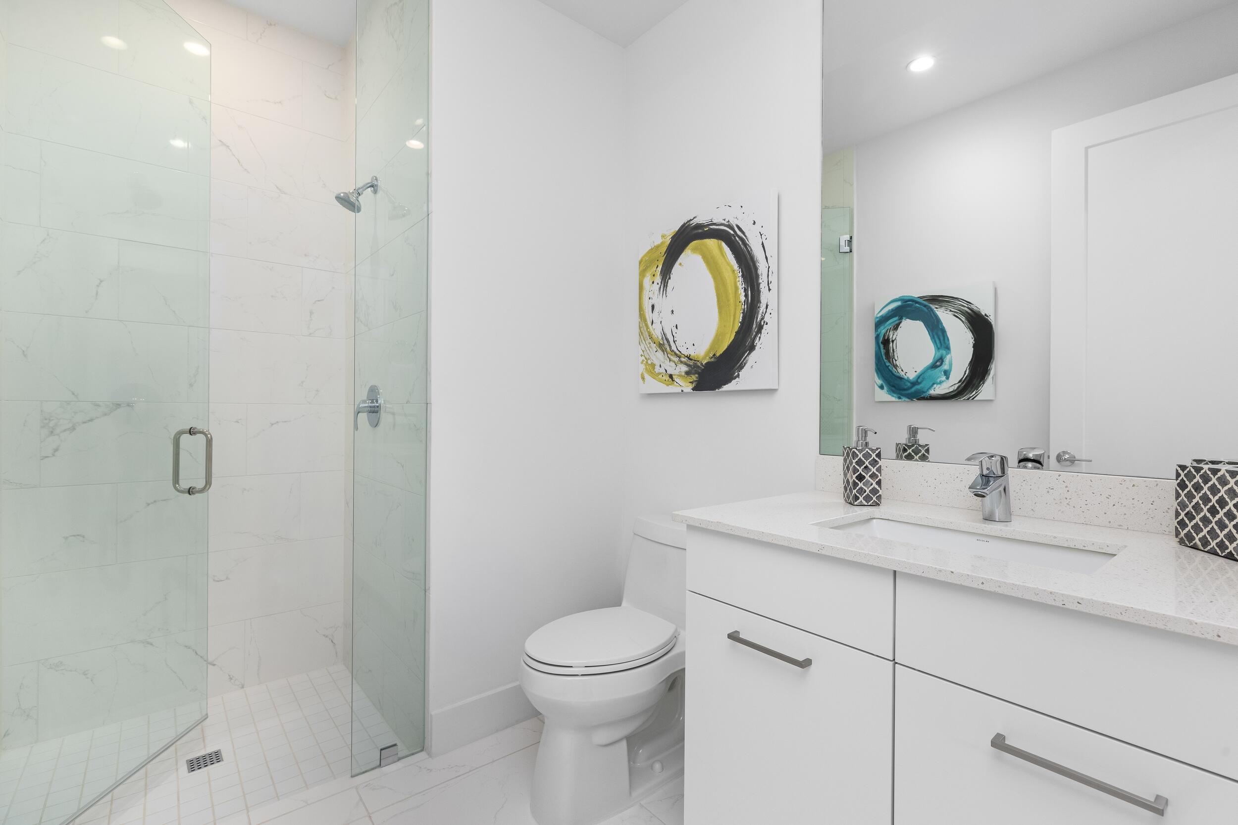 1851 Northwest 40th Drive Boca Raton, FL 33431 - Photo 35 of 42 a bathroom with a toilet a sink and vanity