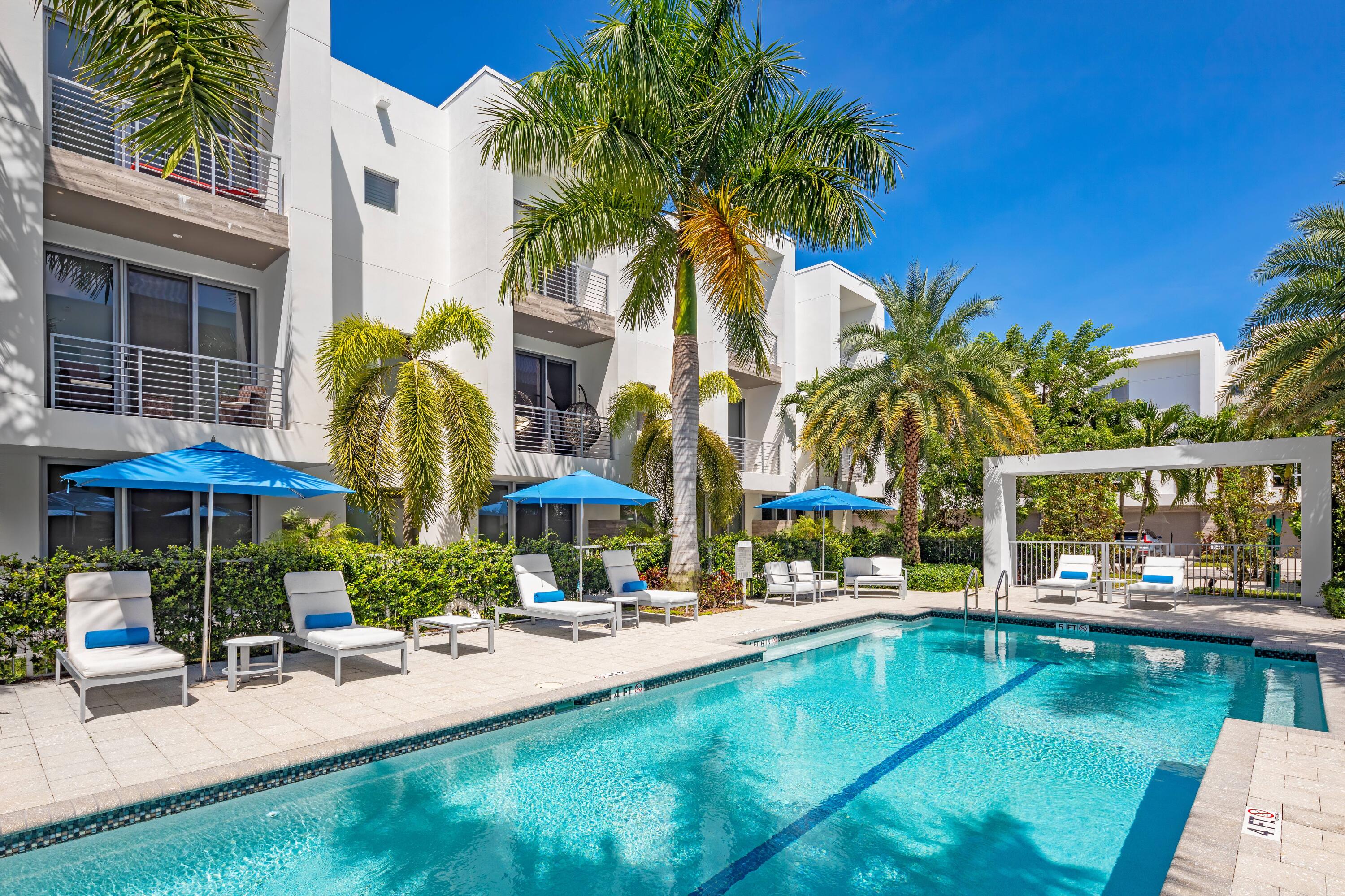 1851 Northwest 40th Drive Boca Raton, FL 33431 - Photo 39 of 42 a swimming pool with outdoor seating and yard