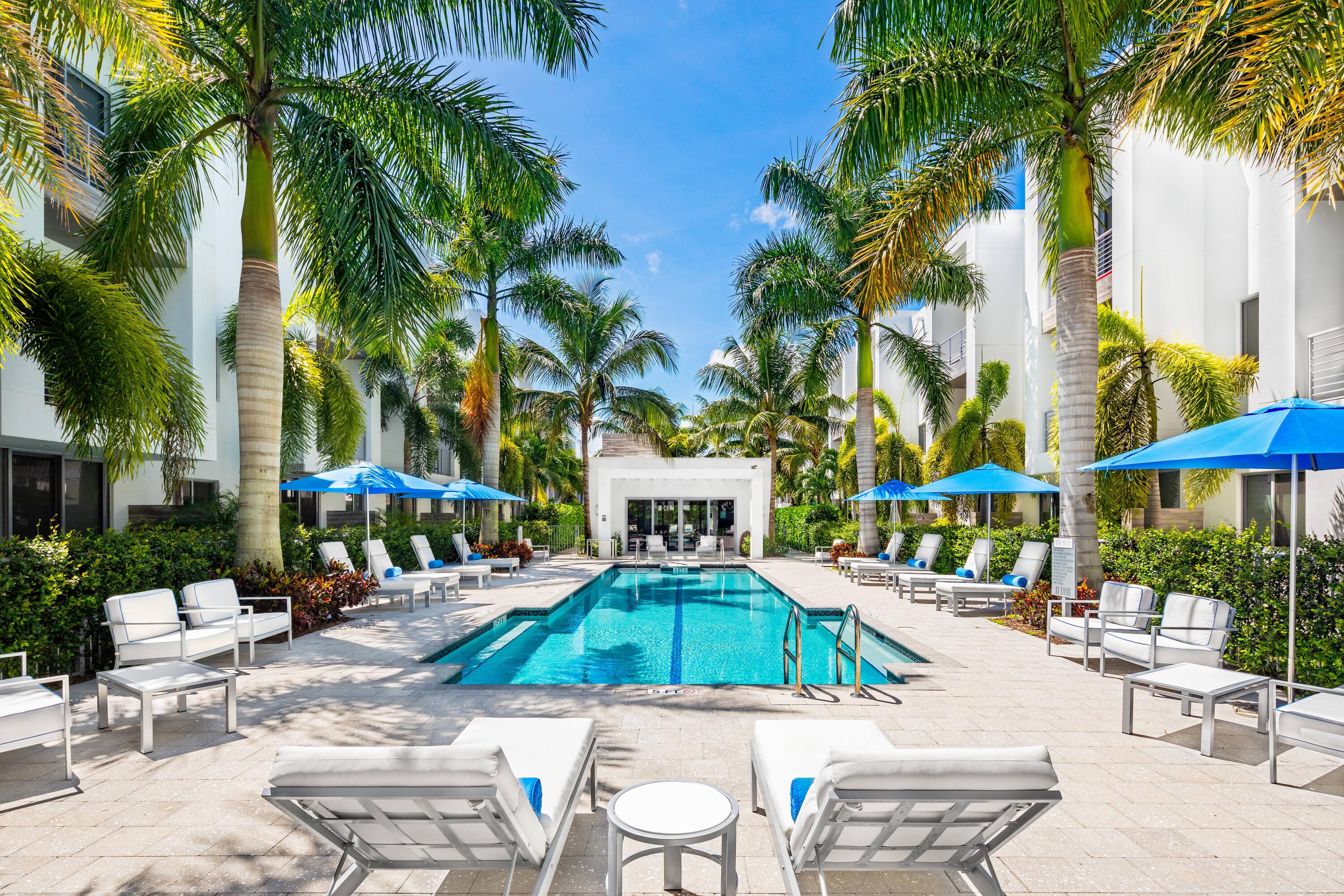 1851 Northwest 40th Drive Boca Raton, FL 33431 - Photo 40 of 42 a view of a patio with swimming pool and chairs