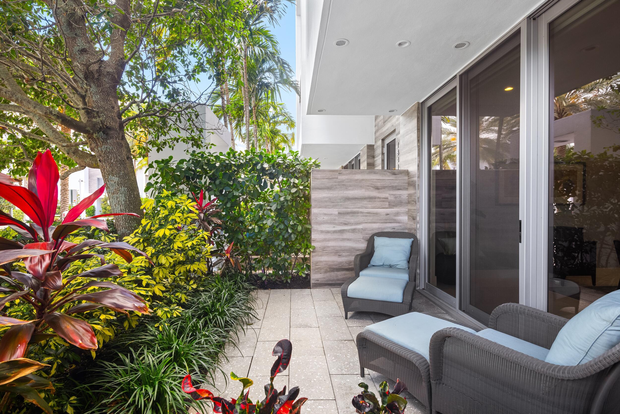 1851 Northwest 40th Drive Boca Raton, FL 33431 - Photo 6 of 42 a balcony with furniture and flowers