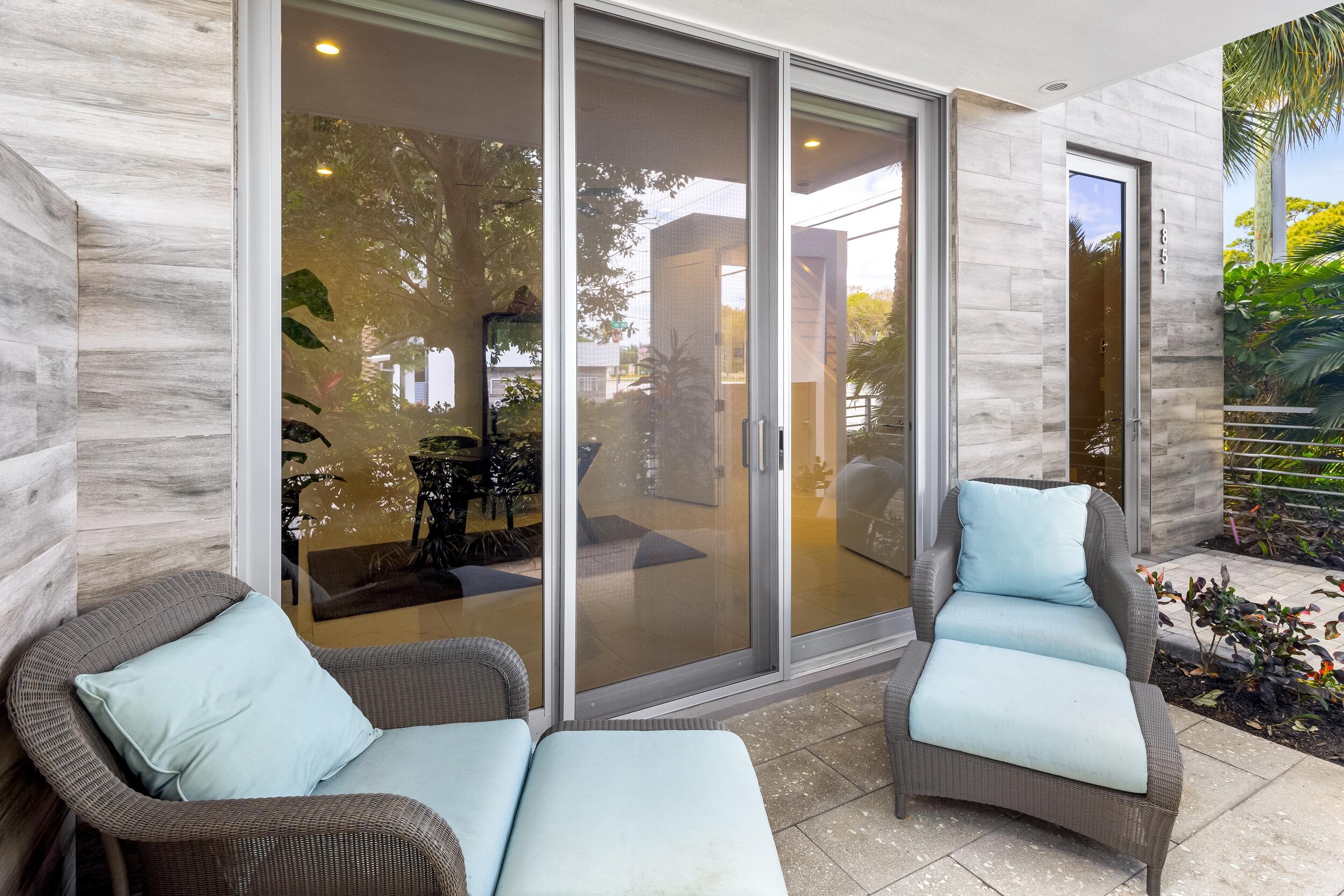 1851 Northwest 40th Drive Boca Raton, FL 33431 - Photo 7 of 42 a living room with furniture and a floor to ceiling window