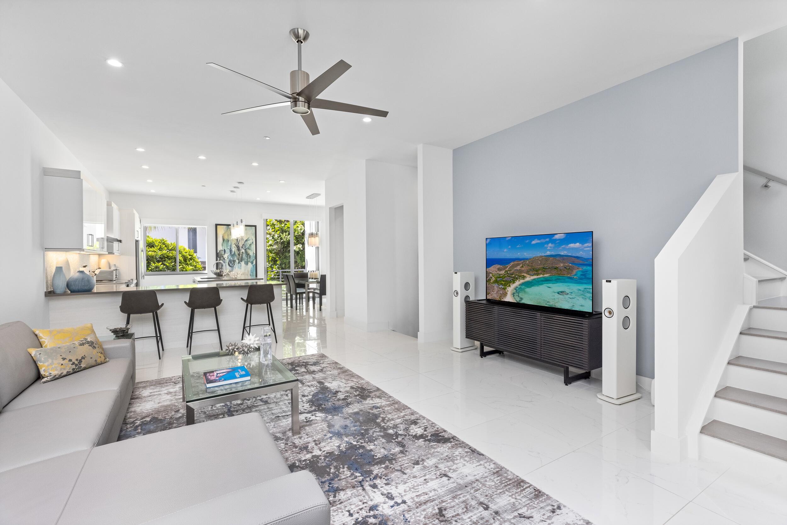 1851 Northwest 40th Drive Boca Raton, FL 33431 - Photo 8 of 42 a living room with furniture a window and a flat screen tv