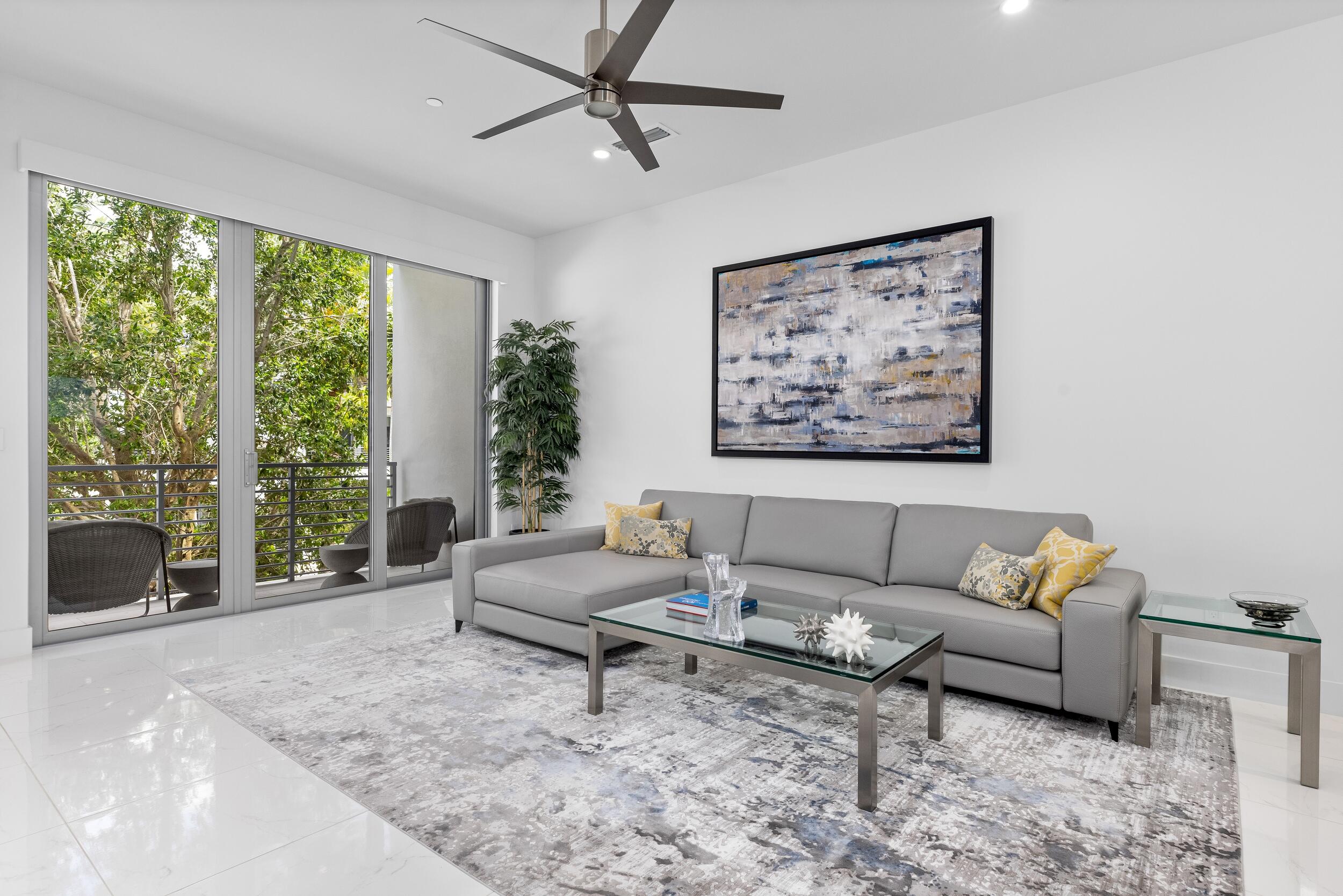 1851 Northwest 40th Drive Boca Raton, FL 33431 - Photo 9 of 42 a living room with furniture and a large window