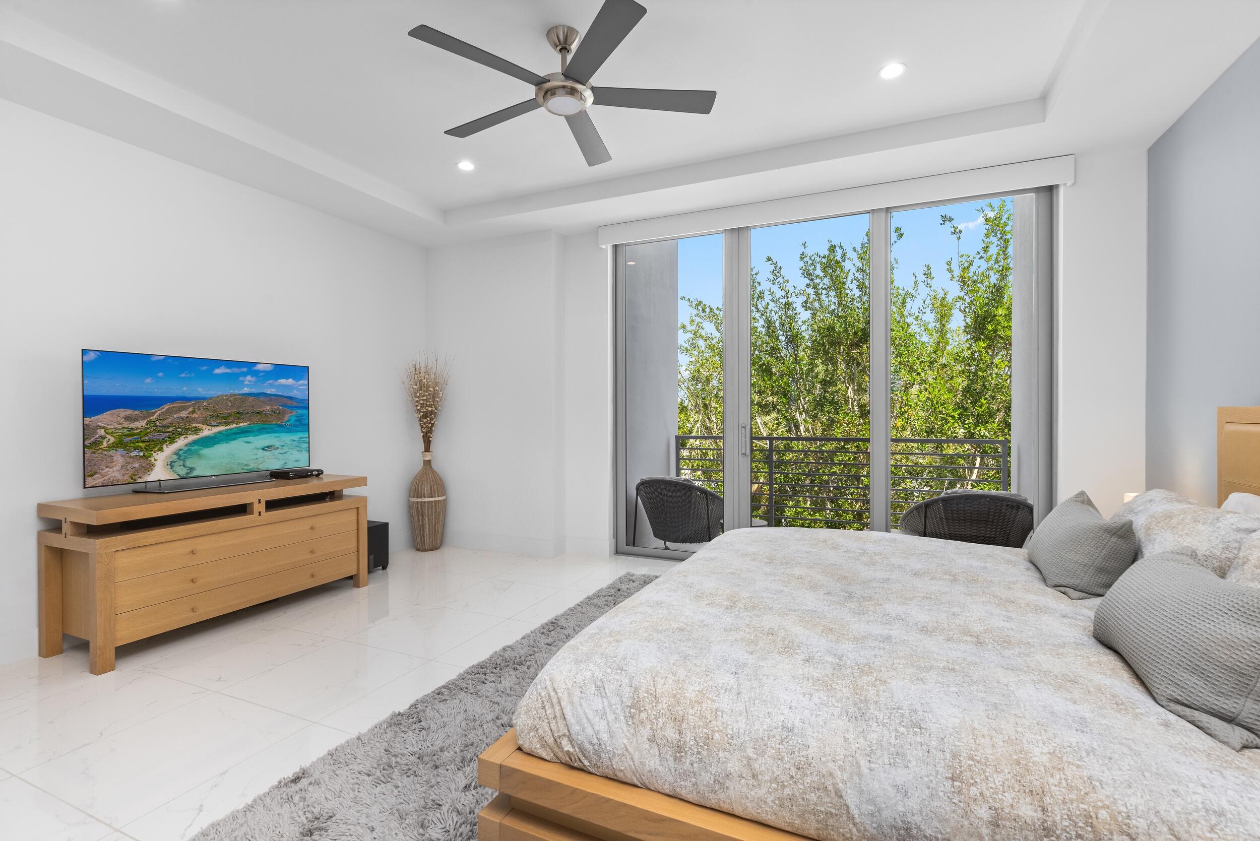1851 Northwest 40th Drive Boca Raton, FL 33431 - Photo 10 of 42 a spacious bedroom with a large bed and a window