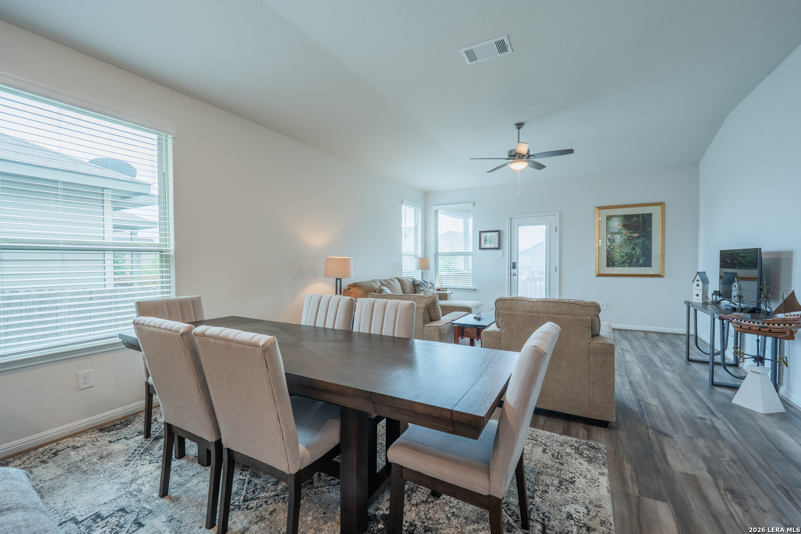 4947 Ranahan Pass St. Hedwig, TX 78152 - Photo 10 of 37 a view of a dining room with furniture window and wooden floor