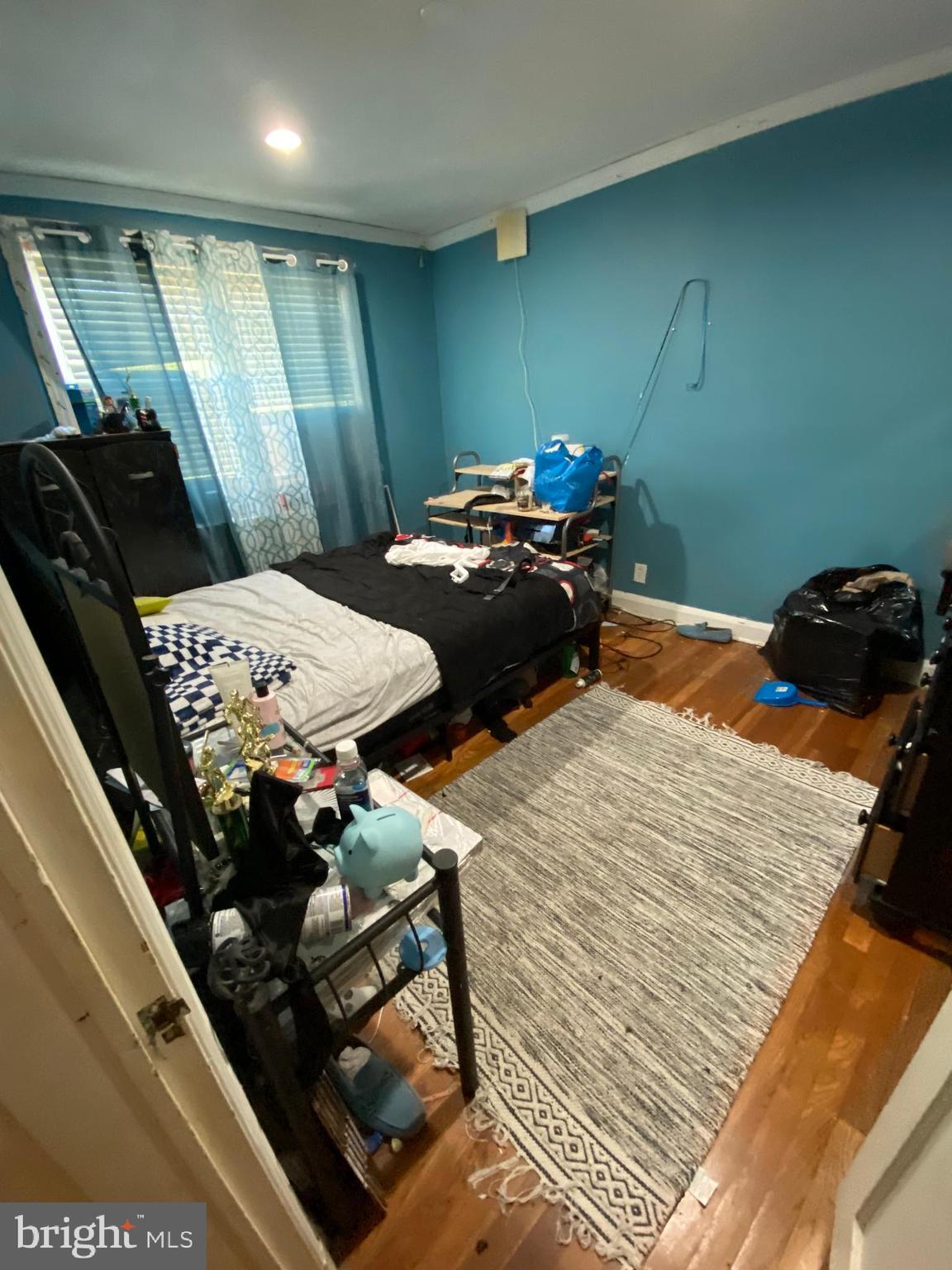450 Random Road Baltimore, MD 21229 - Photo 11 of 17 a bed sitting in a bedroom next to a window