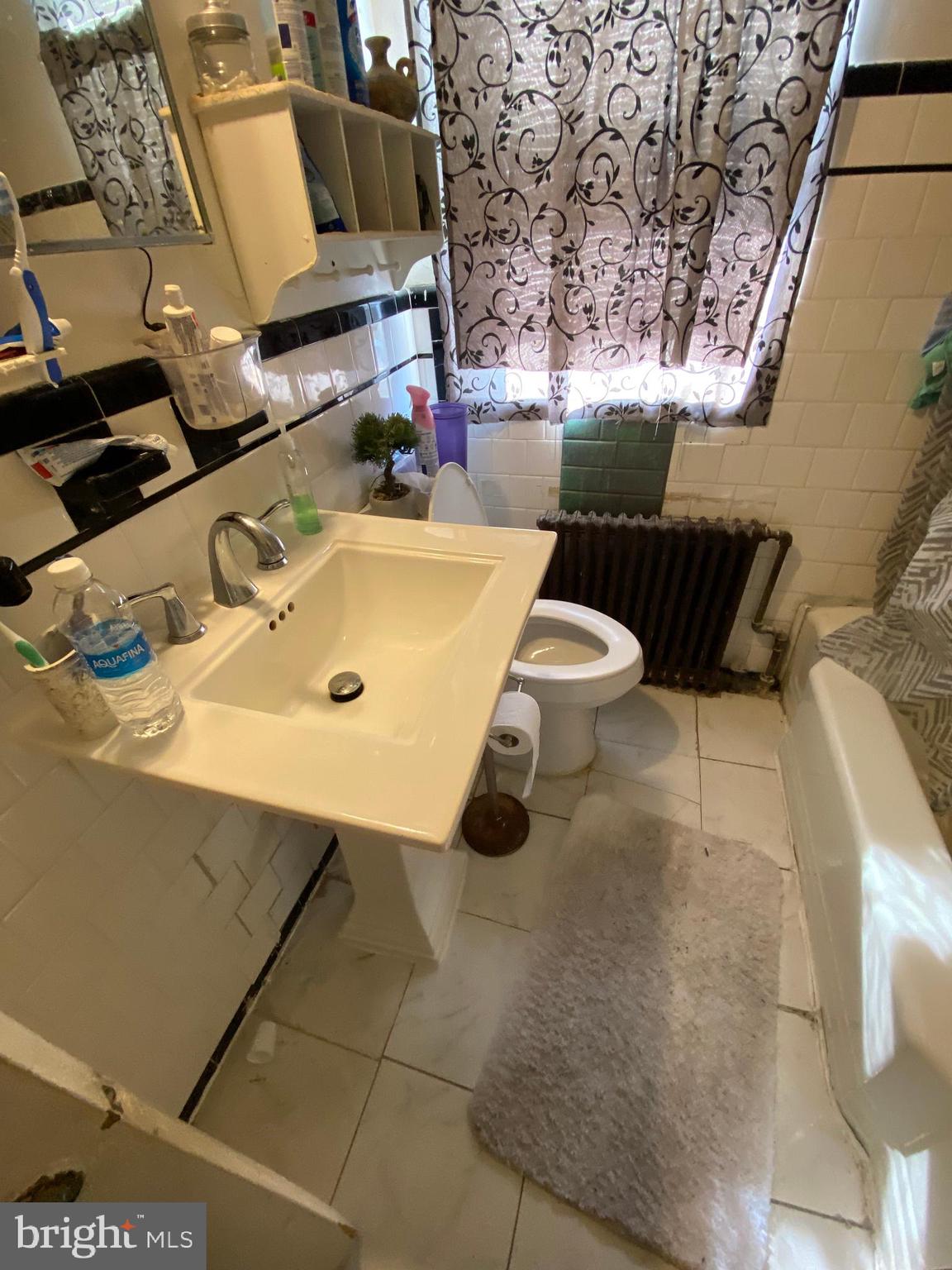 450 Random Road Baltimore, MD 21229 - Photo 8 of 17 a bathroom with a sink toilet and mirror
