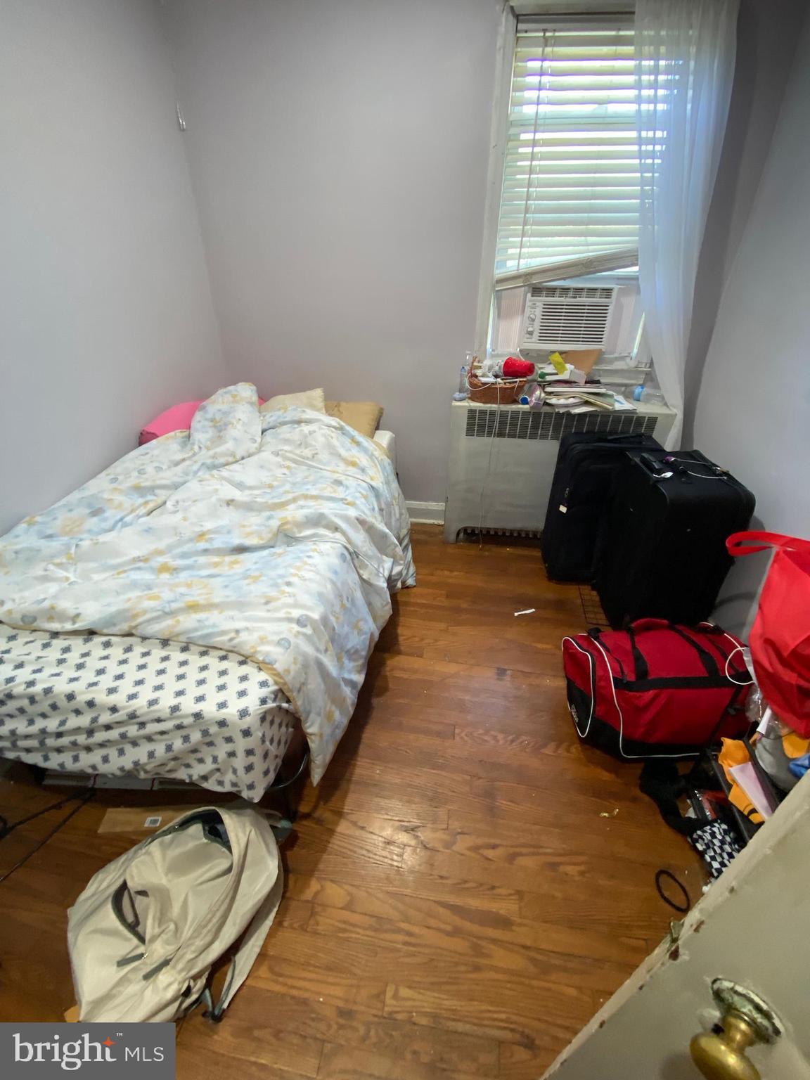 450 Random Road Baltimore, MD 21229 - Photo 10 of 17 a bedroom with bed and window