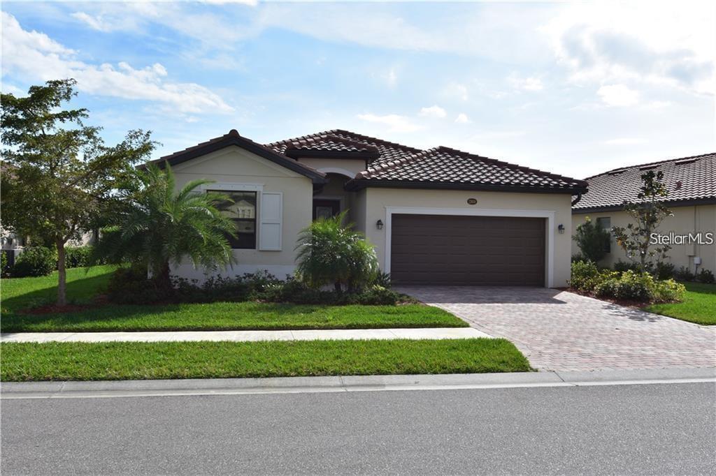 12659 Richezza Drive Venice, FL 34293 - Photo 1 of 42 a front view of a house with a garden and plants