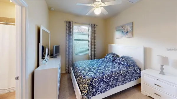 a bedroom with a bed and a chandelier