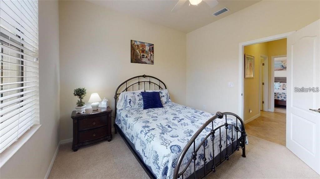 12659 Richezza Drive Venice, FL 34293 - Photo 18 of 42 a bedroom with a bed and a window