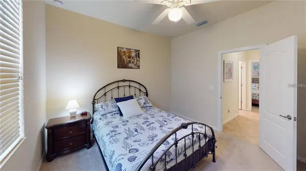 a bedroom with a bed and a dresser with mirror