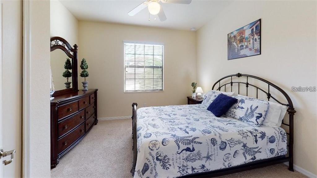 12659 Richezza Drive Venice, FL 34293 - Photo 20 of 42 a bedroom with a bed next to a window