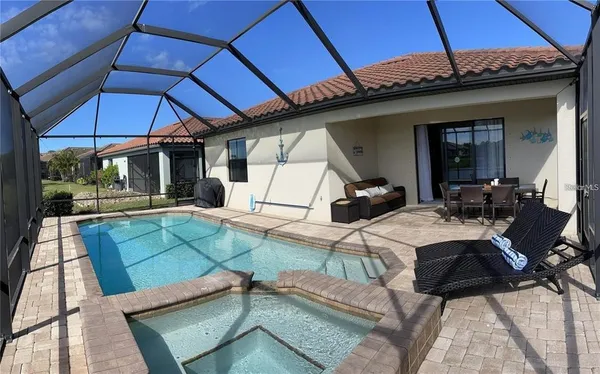a view of a patio with table and chairs under an umbrella