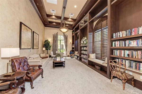 a living room with furniture and a book shelf