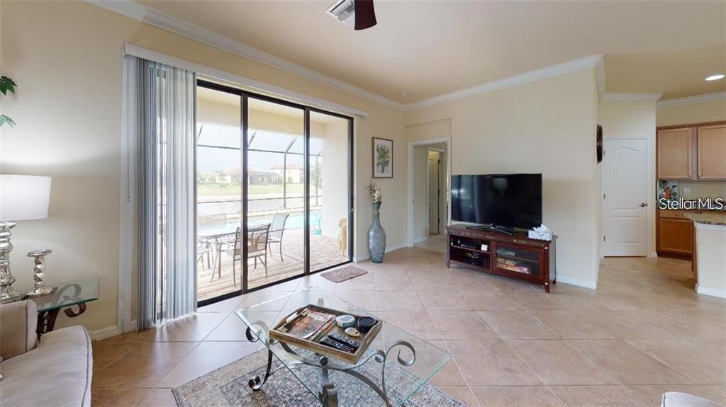 12659 Richezza Drive Venice, FL 34293 - Photo 4 of 42 a living room with furniture and a flat screen tv