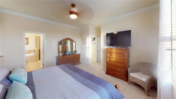 a bedroom with a bed and a television