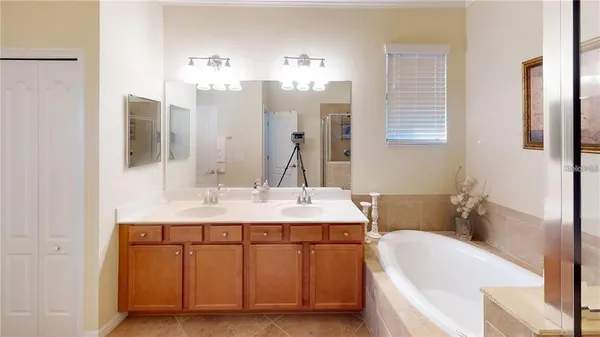 a bathroom with a tub sink and mirror
