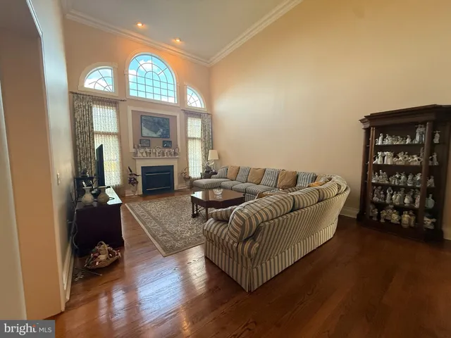 a living room with furniture fireplace and a large window